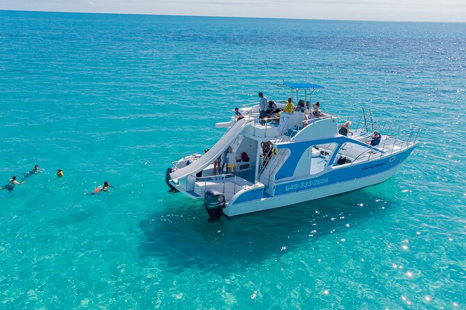 Private 4-Hour Catamaran Tour from Providenciales in Turks and Caicos - Snorkeling, swimming, and crew help in the water